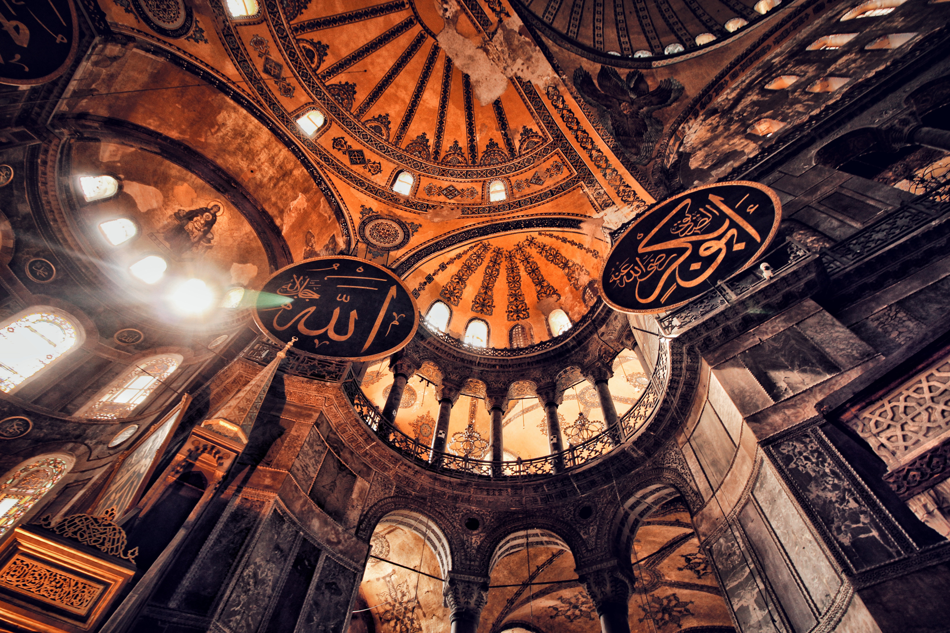 Interior Hagia Sophia domes that appear full of gold and light with patterns and designs engraved and painted onto them
