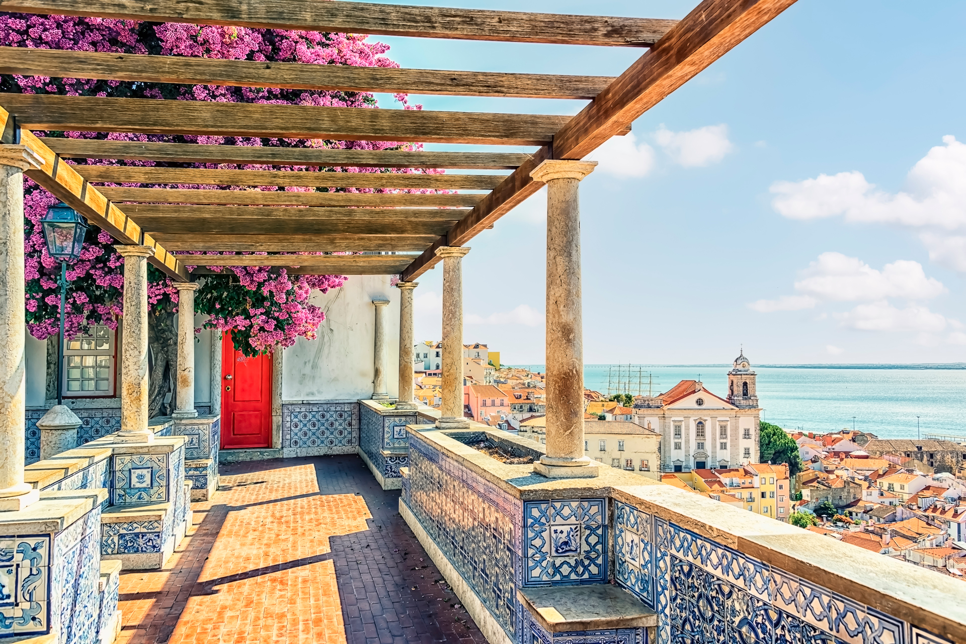 A terrace with patterned design looking over a coastal aera in Lisbon