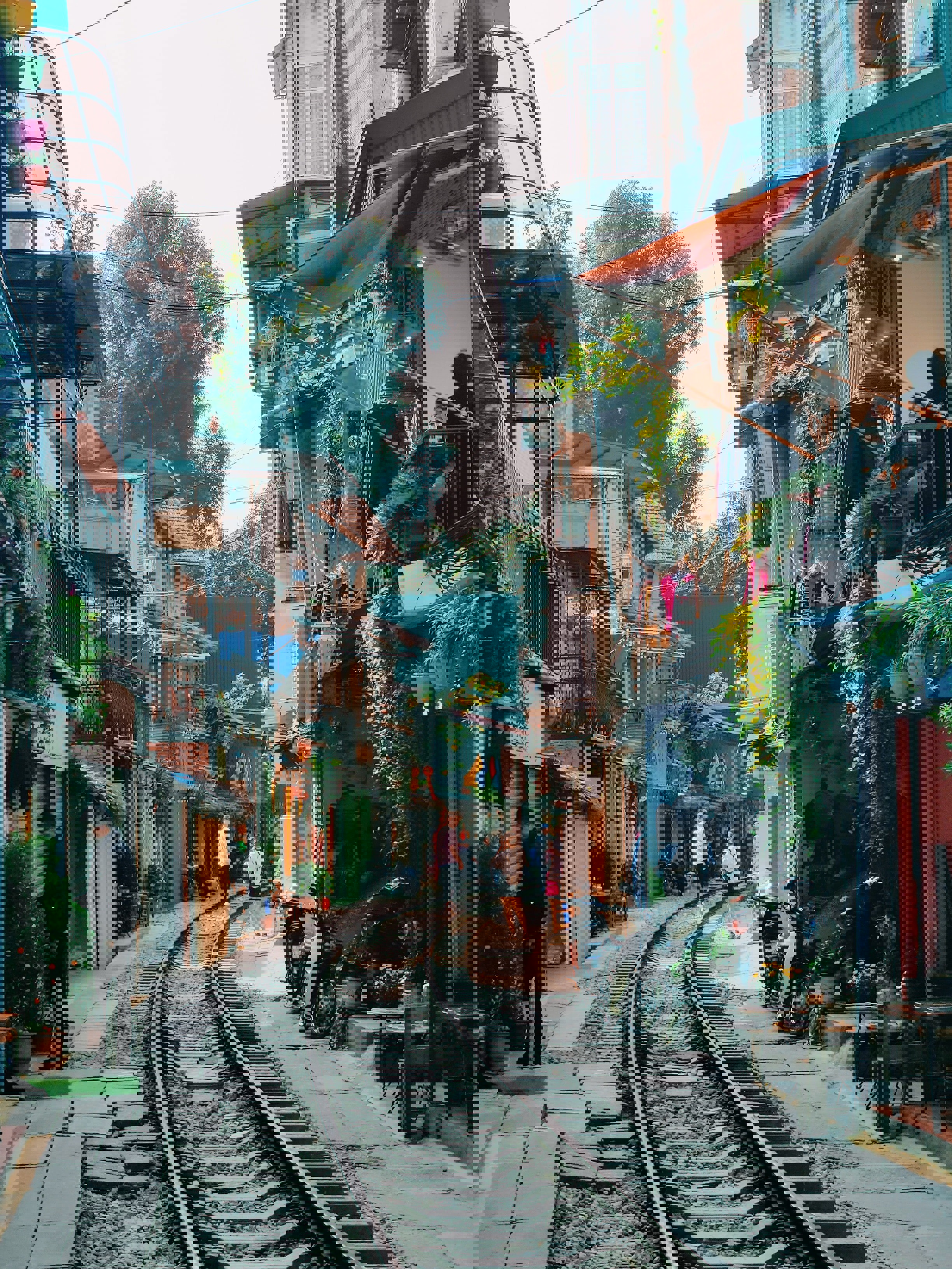 People walking along the traintracks running through Hanoi