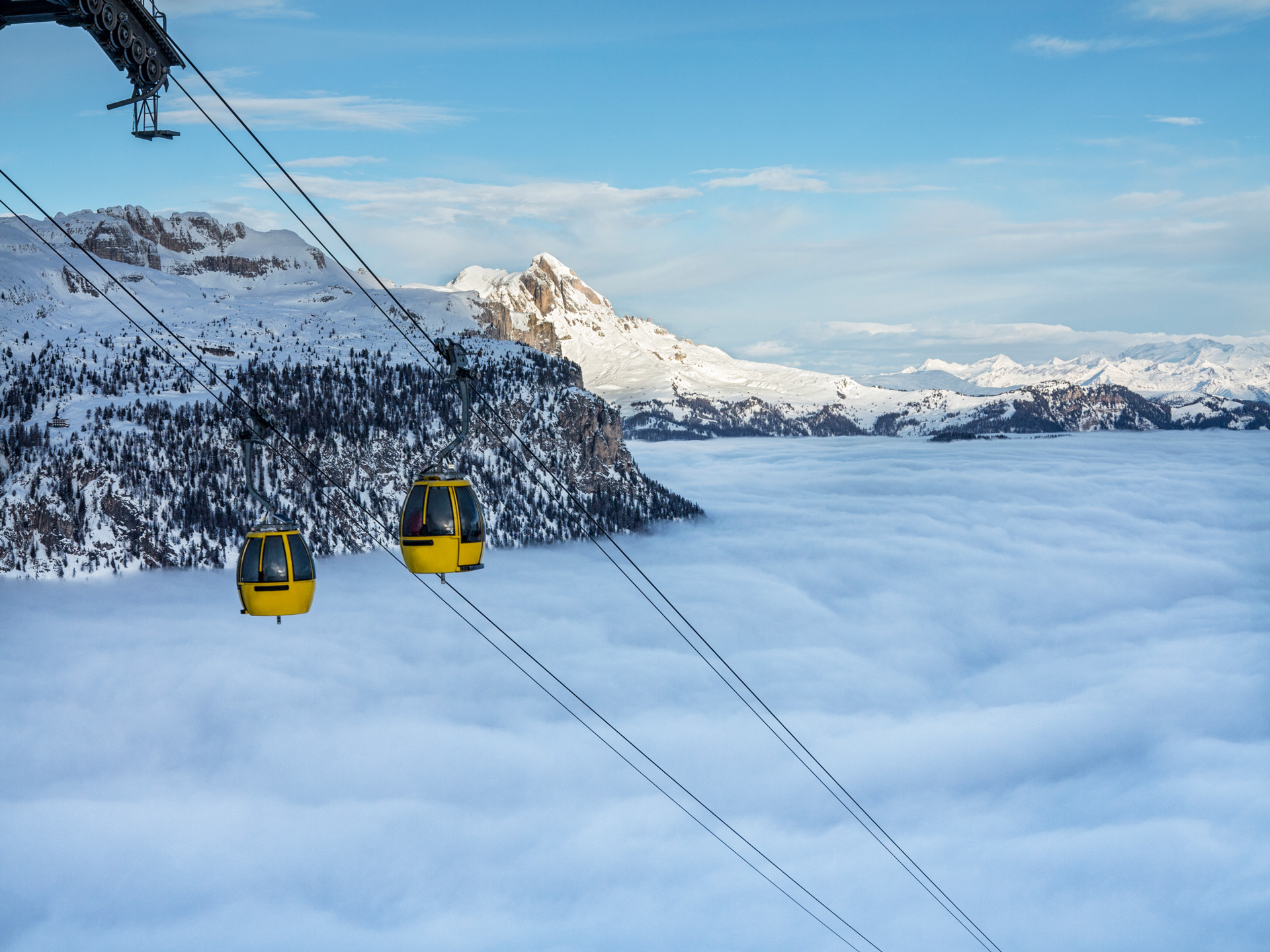 Ski lifts above the clouds in the Dolomites