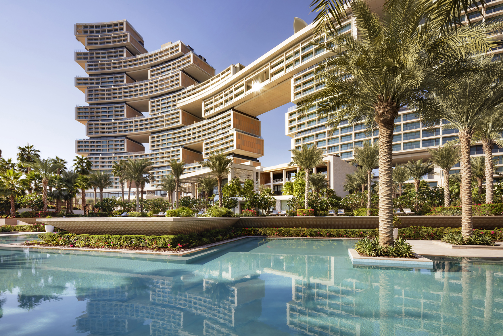 Arabia, UAE, Dubai, Atlantis The Royal, pool, palm trees and buidling facade