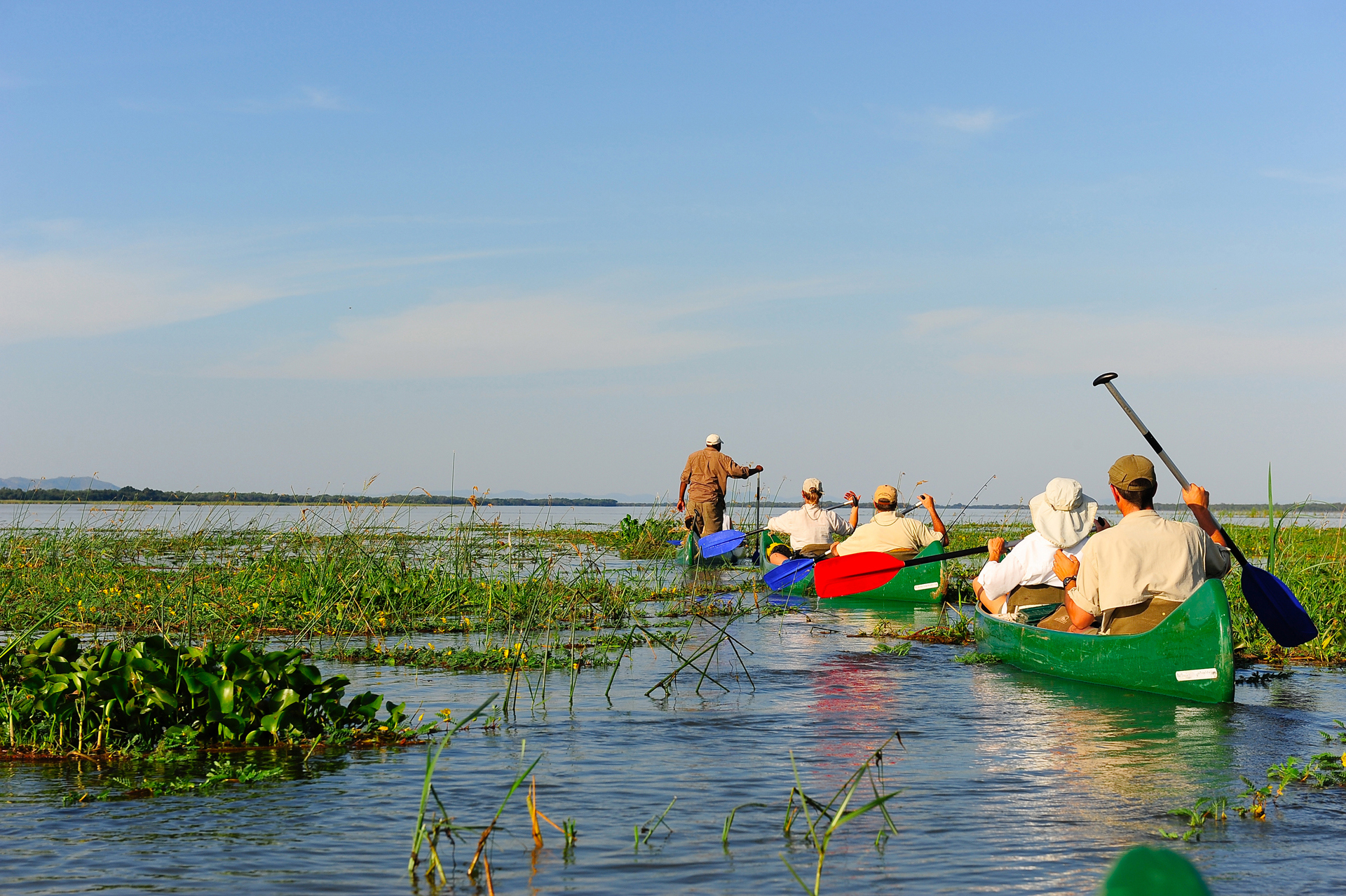 a group of people in canoes on a lake