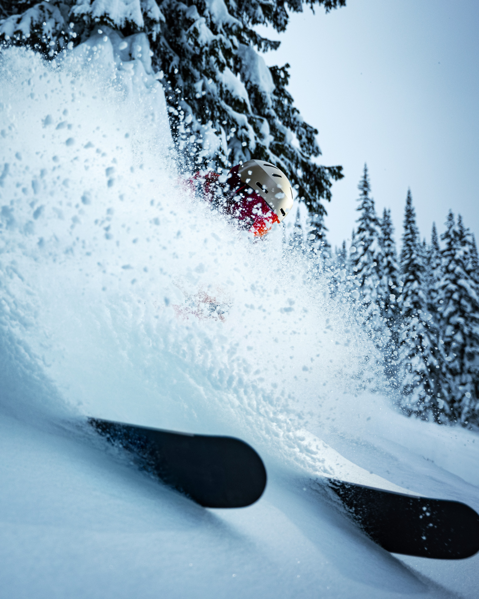 A close up of a skier kicking up powdery snow