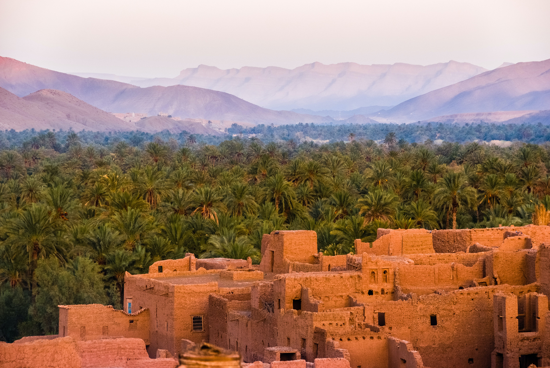 View of old buildings, trees and mountains