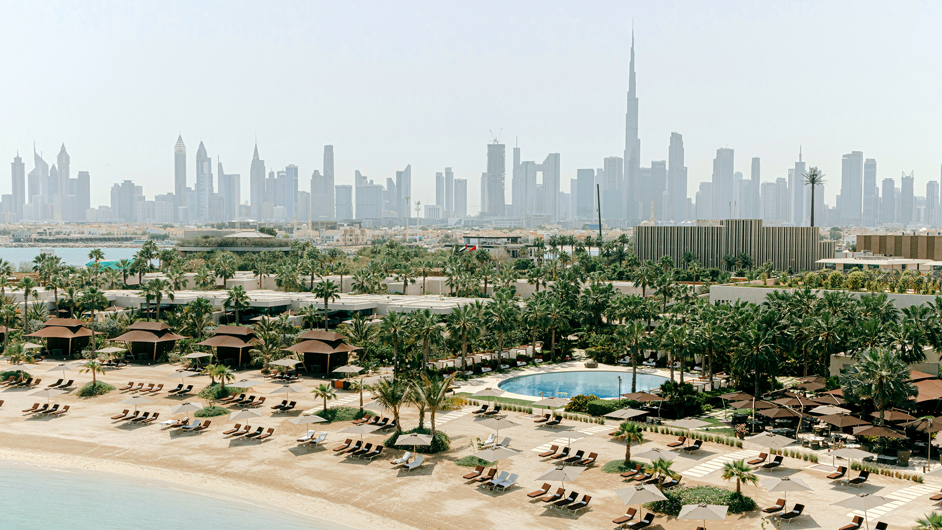 Arabia, Dubai, Bulgari Resort, view of the beach with city skyline in the background