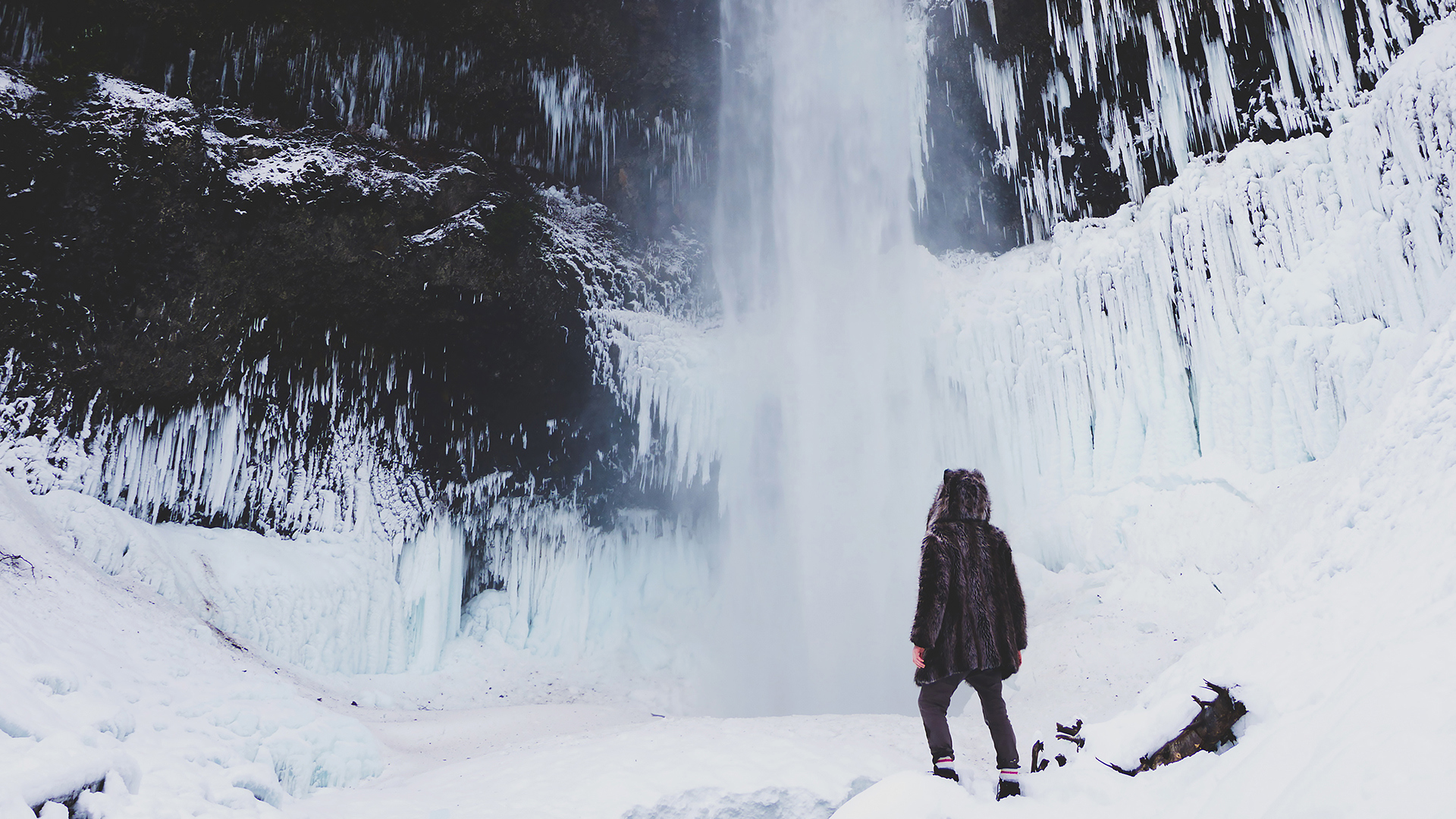 Luxury Ski & Snow, Person stood near snowy waterfall