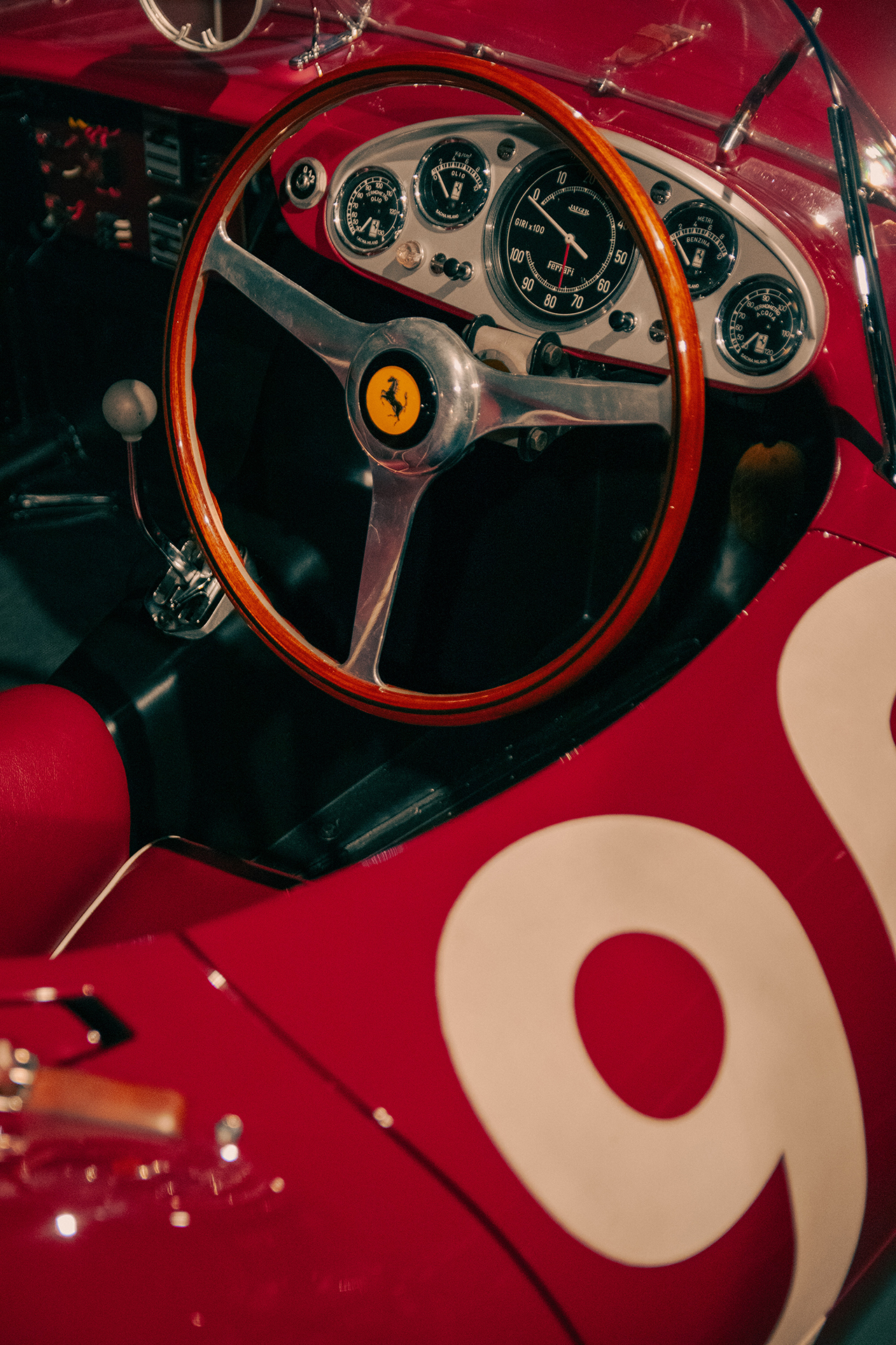 The steering wheel and dashboard of an old Ferrari race car