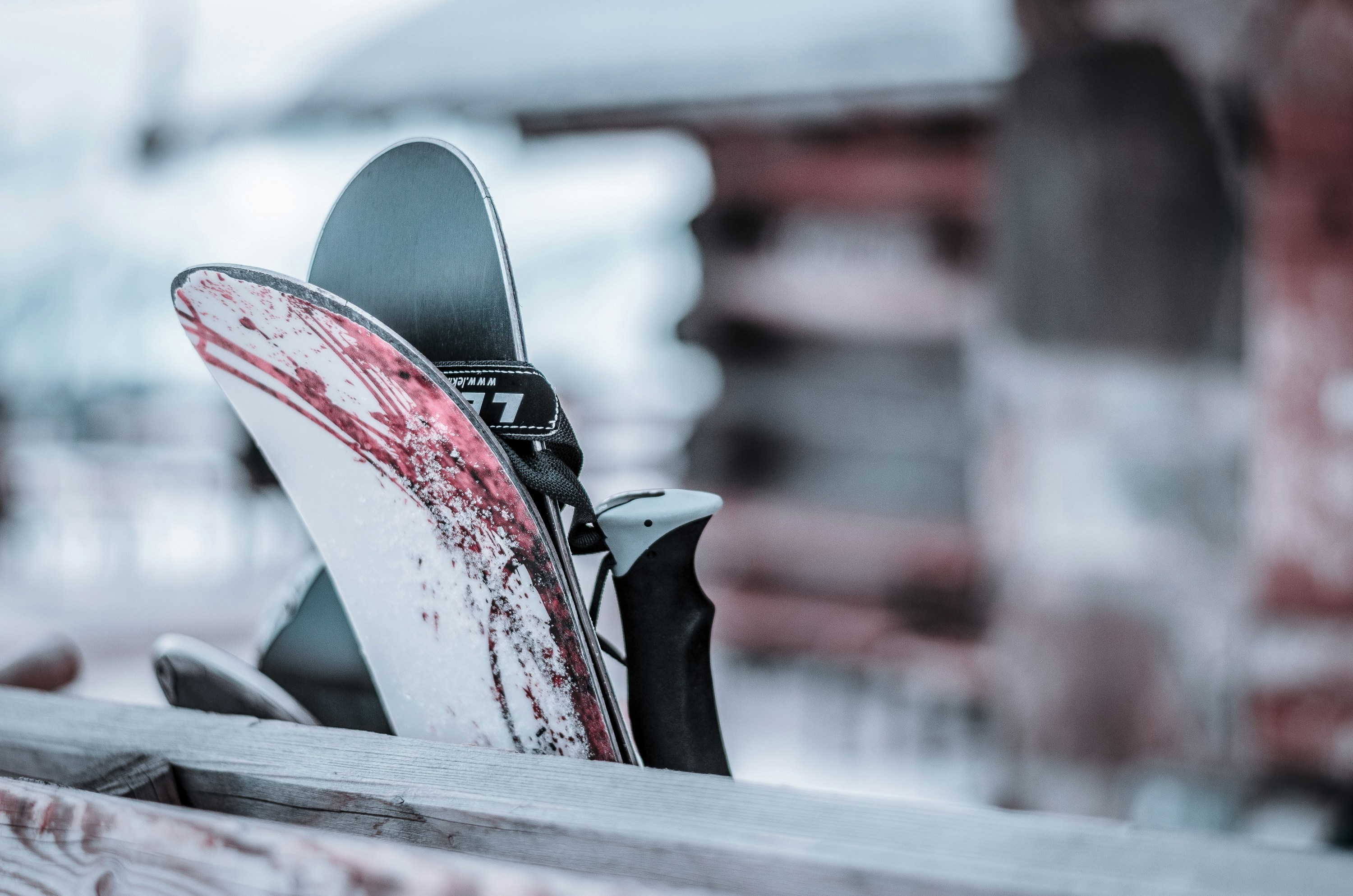 A close-up of skis and bindings, with a focus on the textures and snow residue, suggesting recent use or preparation for skiing