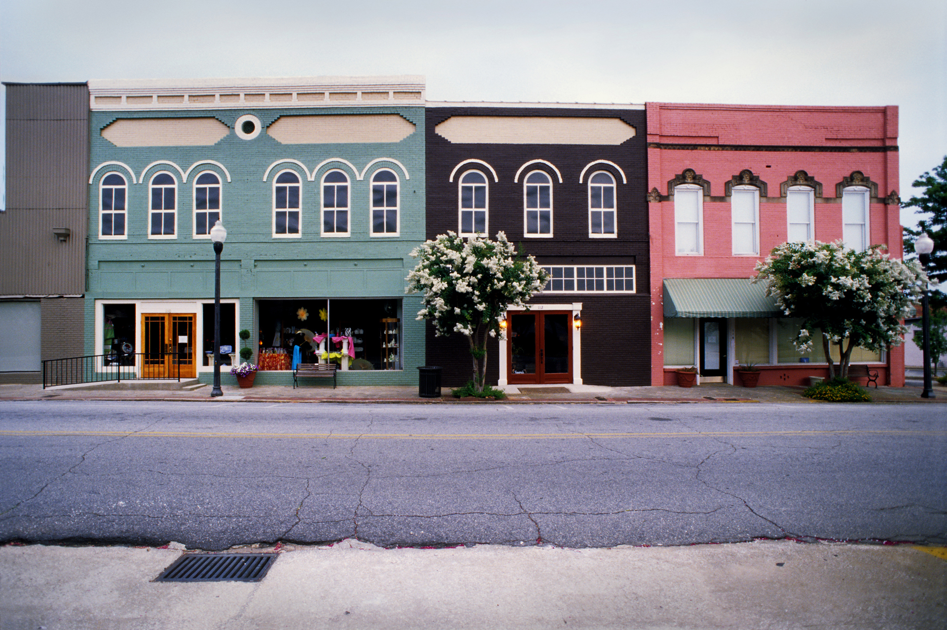 Coloured buildings across a road in Americus, Georgia