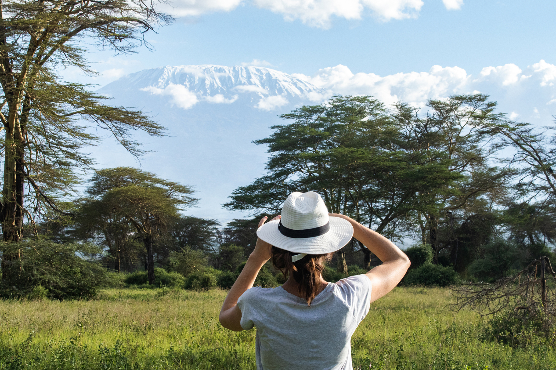 Africa, Kenya, Angama Amboseli, woman looking out onto Kimana Sanctuary