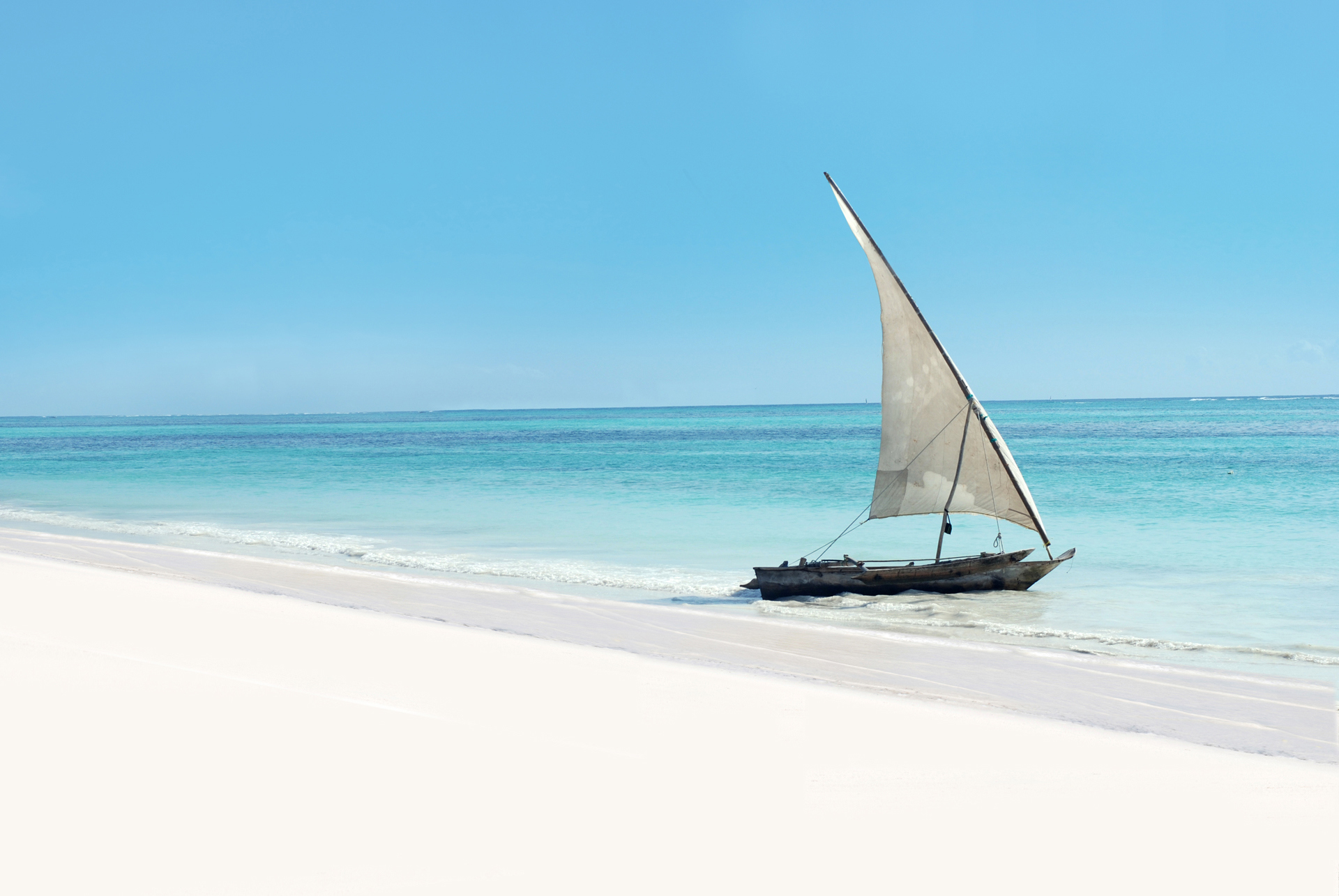 A sail boat at waters edge