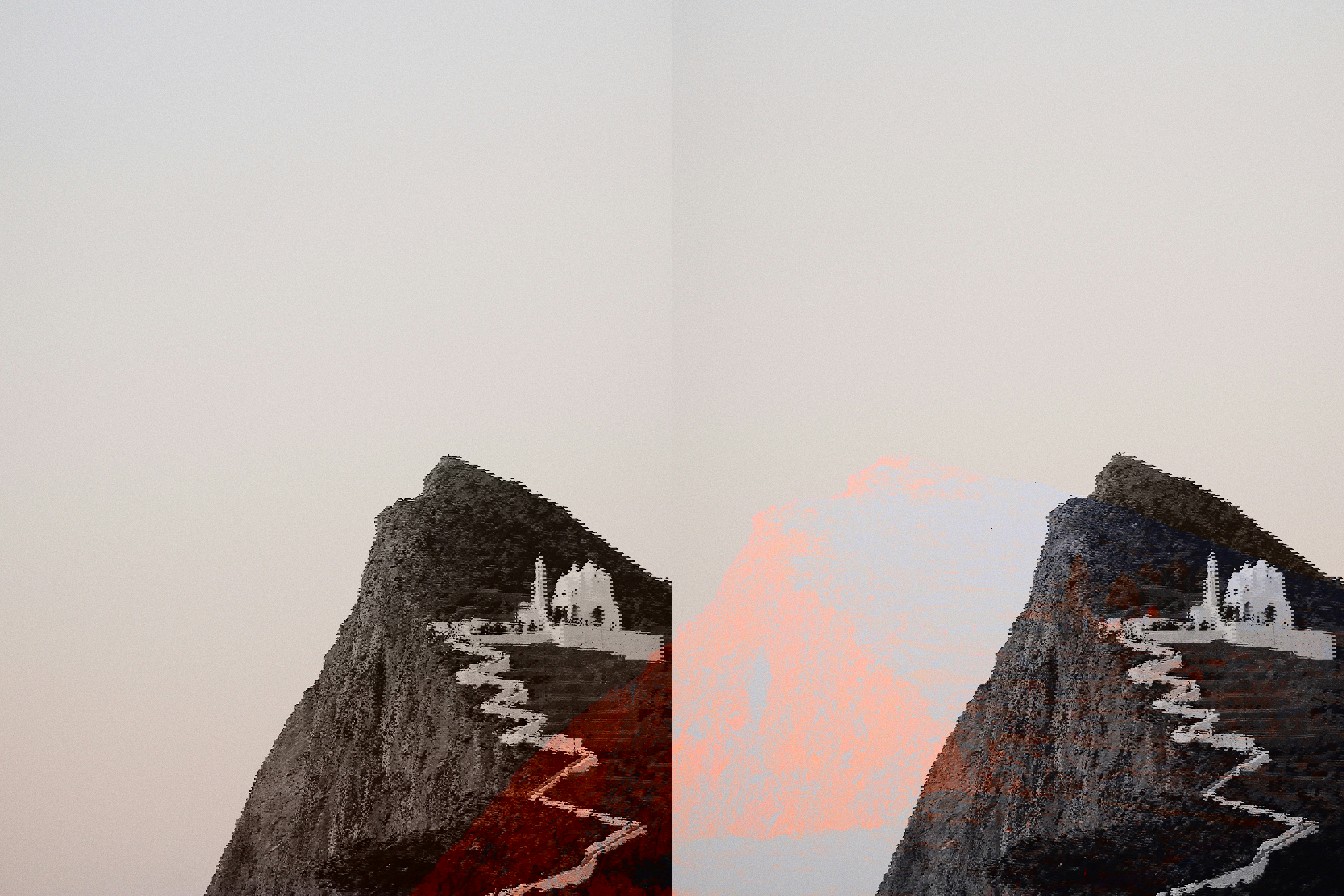 Hill top with white pathway leading up to a Chora on Folegandros at sunset