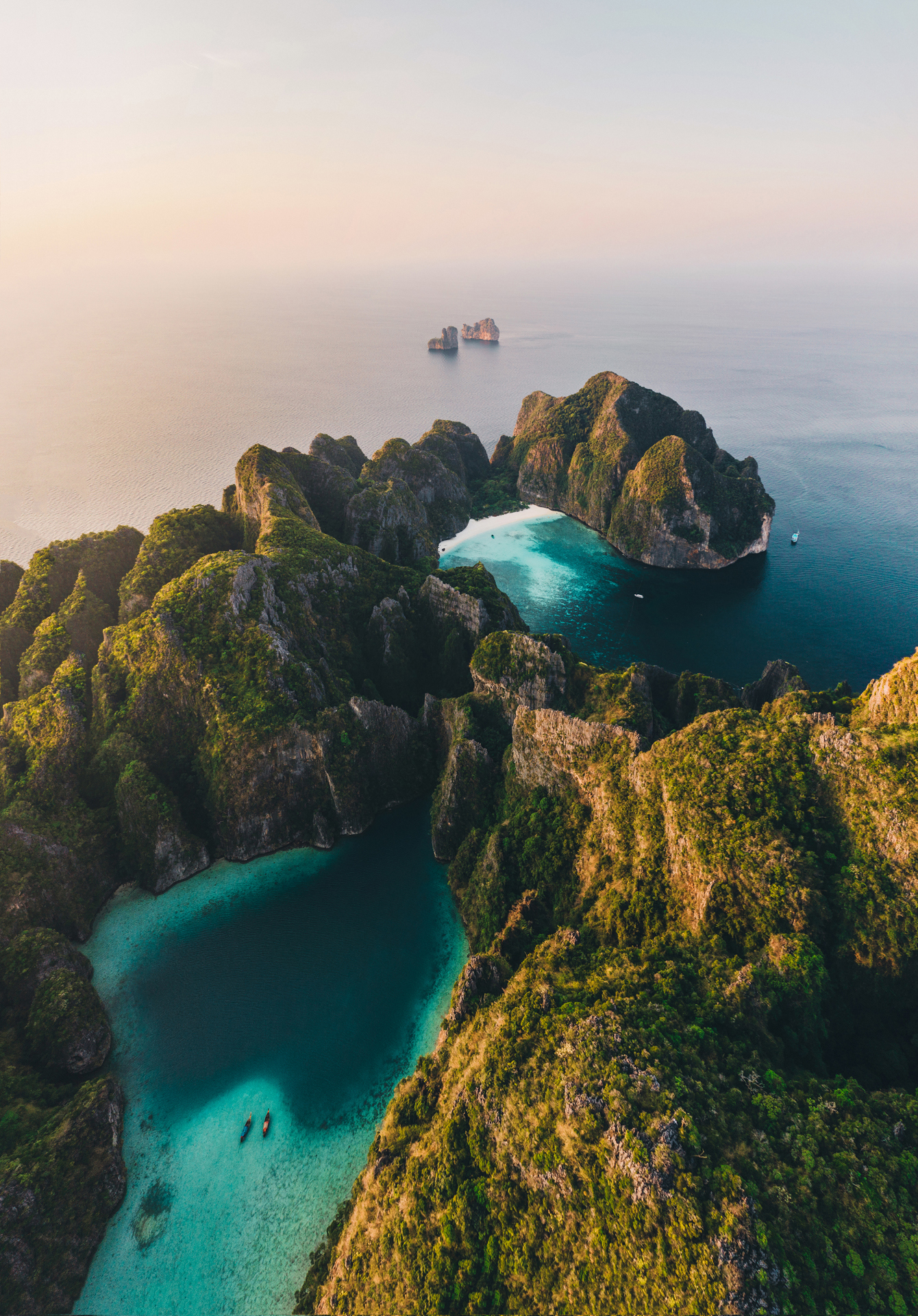Aerial view of Phi Phi Island and coastline with two boats in the shallow water