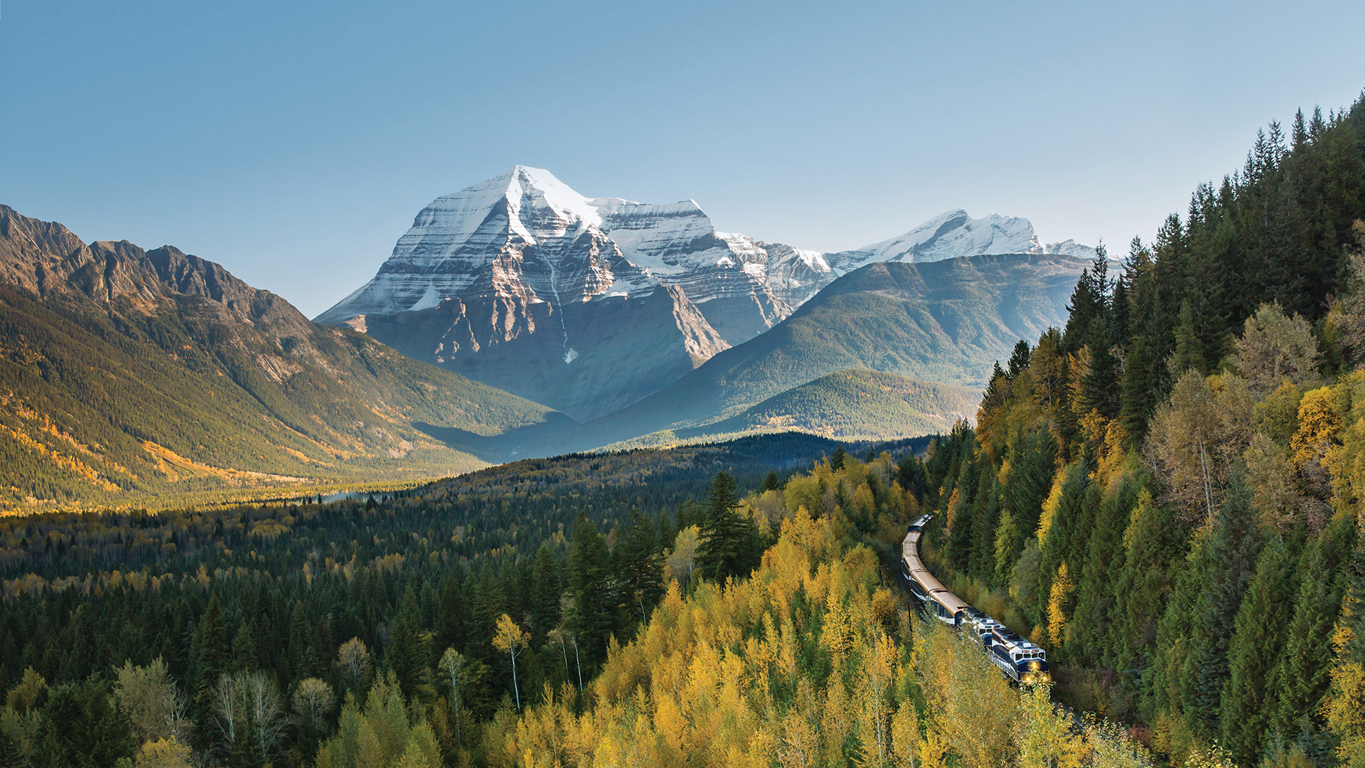 A Rocky Mountaineer train with Mount Robson in the background, the highest point in the Canadian Rockies